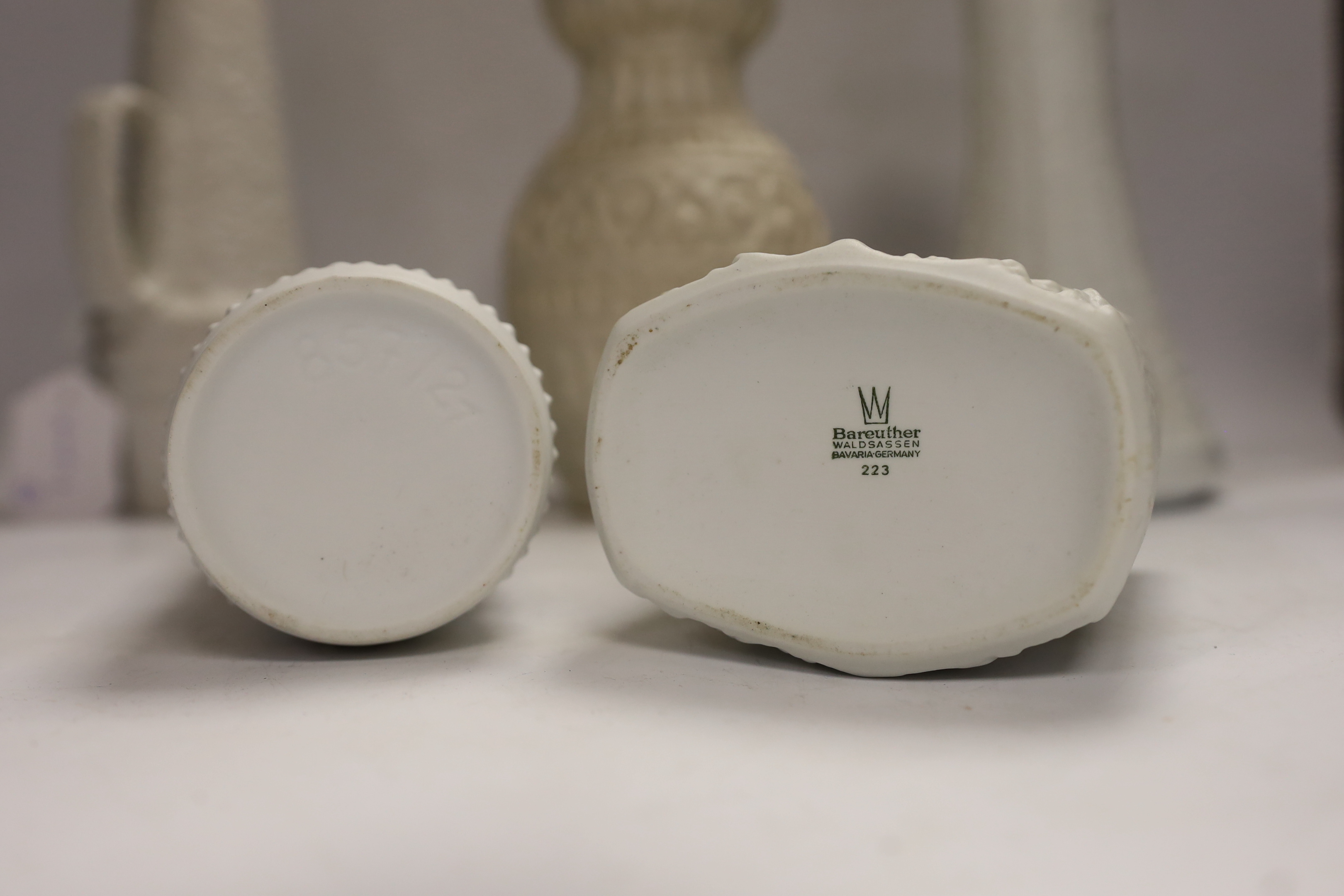 Five West German pottery and biscuit porcelain vases, tallest 24cm